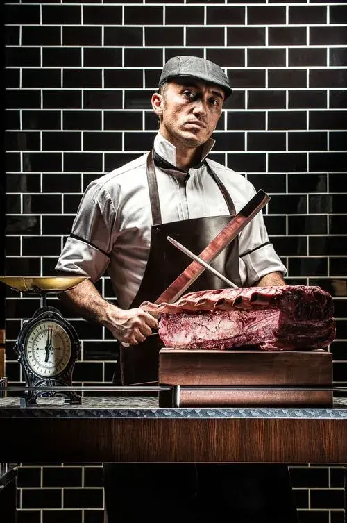 Butcher knives beside a rib roast