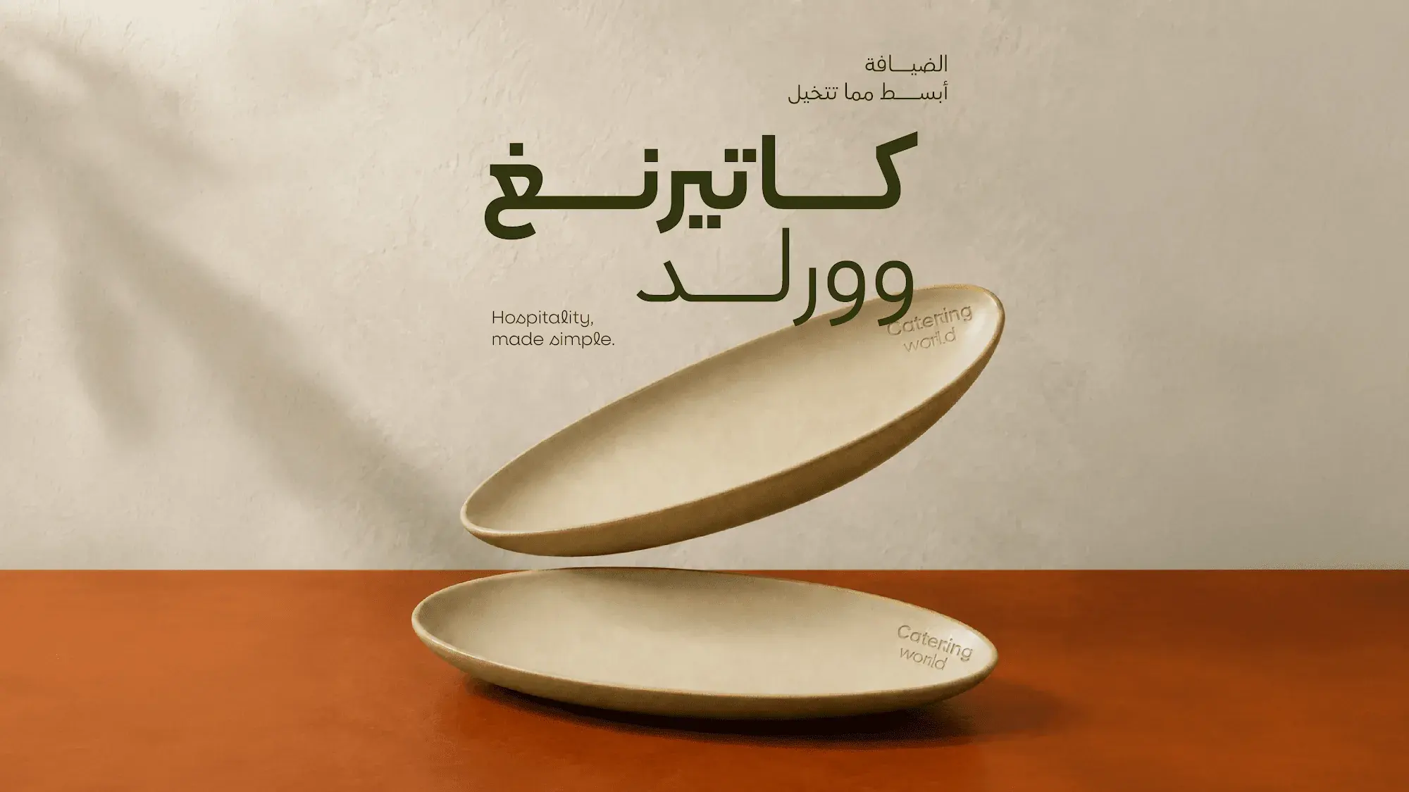 Two ceramic plates, one floating, with the Catering World name in Arabic