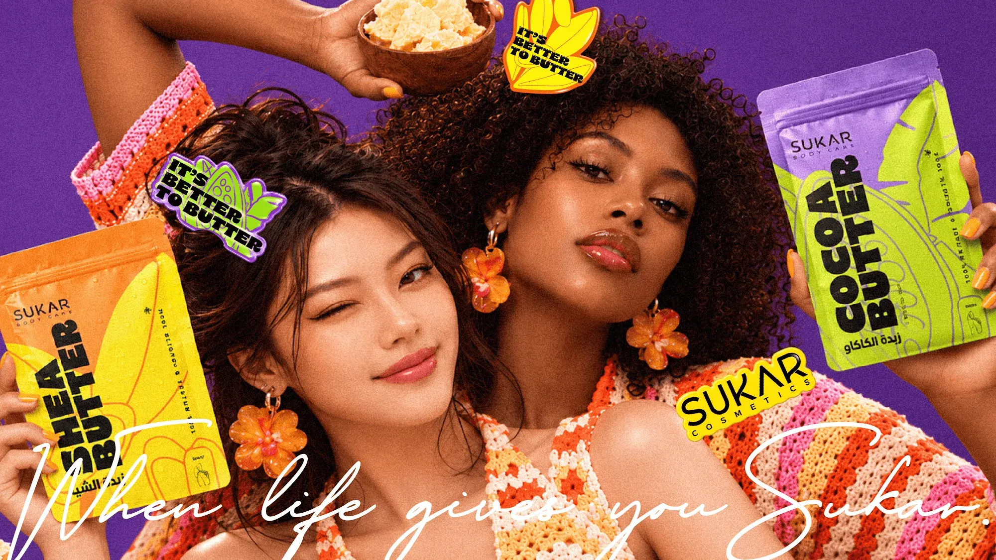 Two women holding Shea Butter and Coco Butter pouches