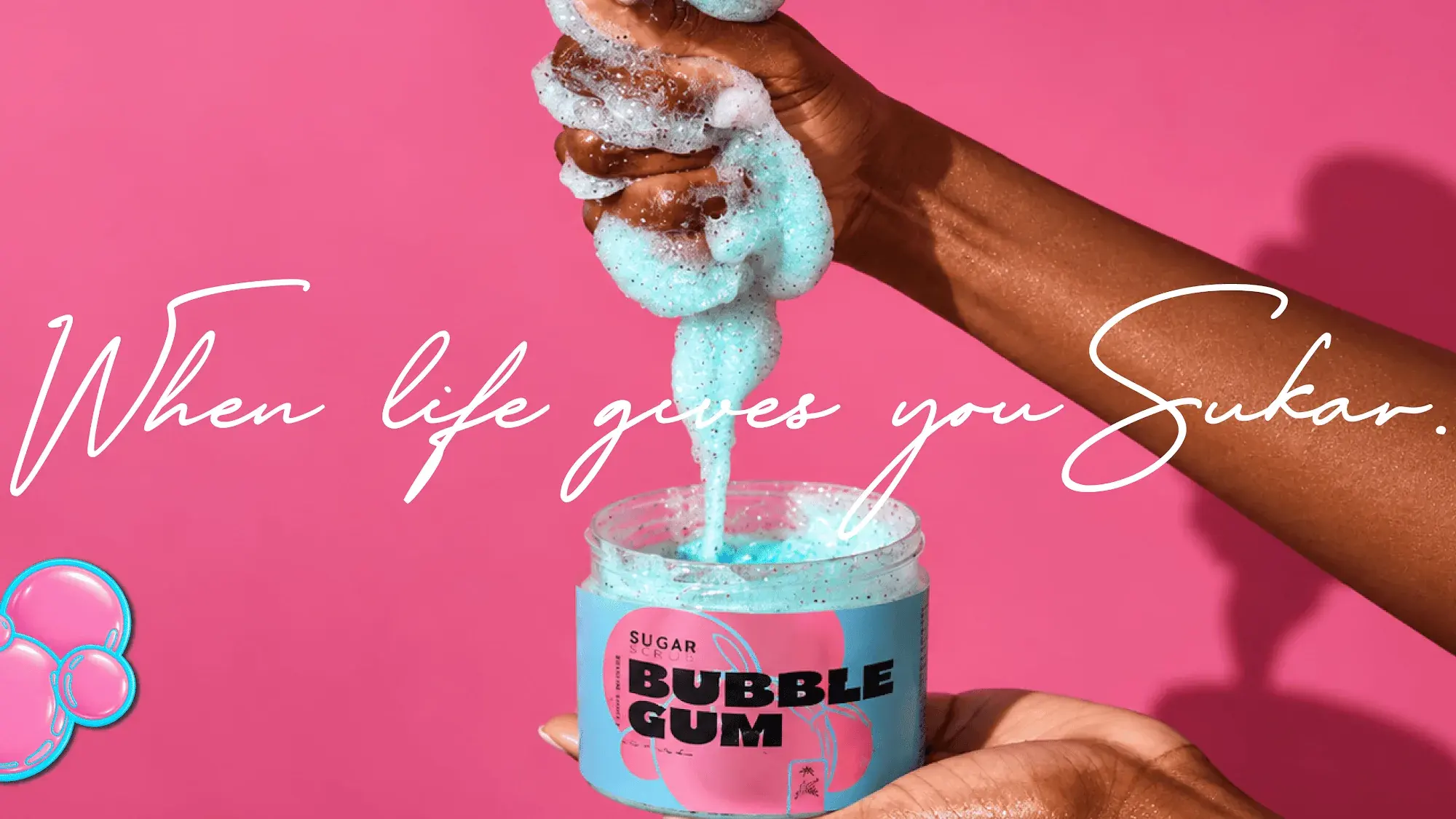 Hands squeezing blue bubble gum scrub back into the Sukar jar