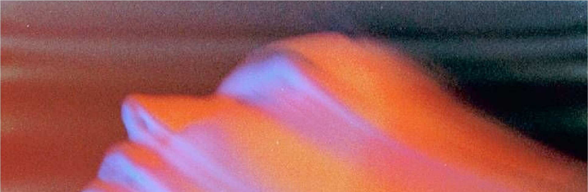 Abstract neon light streaks in orange, pink, and blue across a dark field